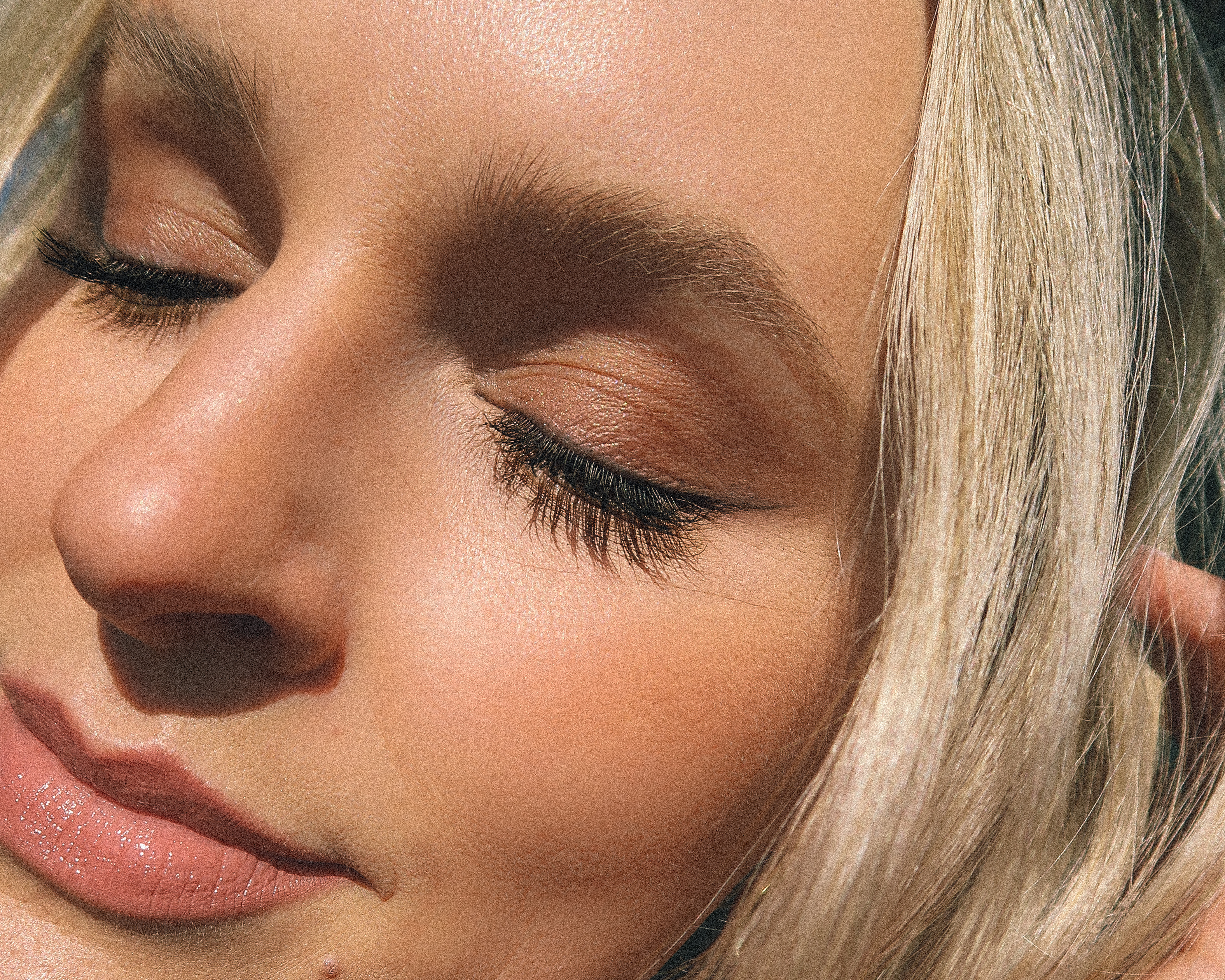 Close up of eyelashes shown on closed eyes with a shadow of the lashes underneath the actual lashes in order to showcase clean mascara